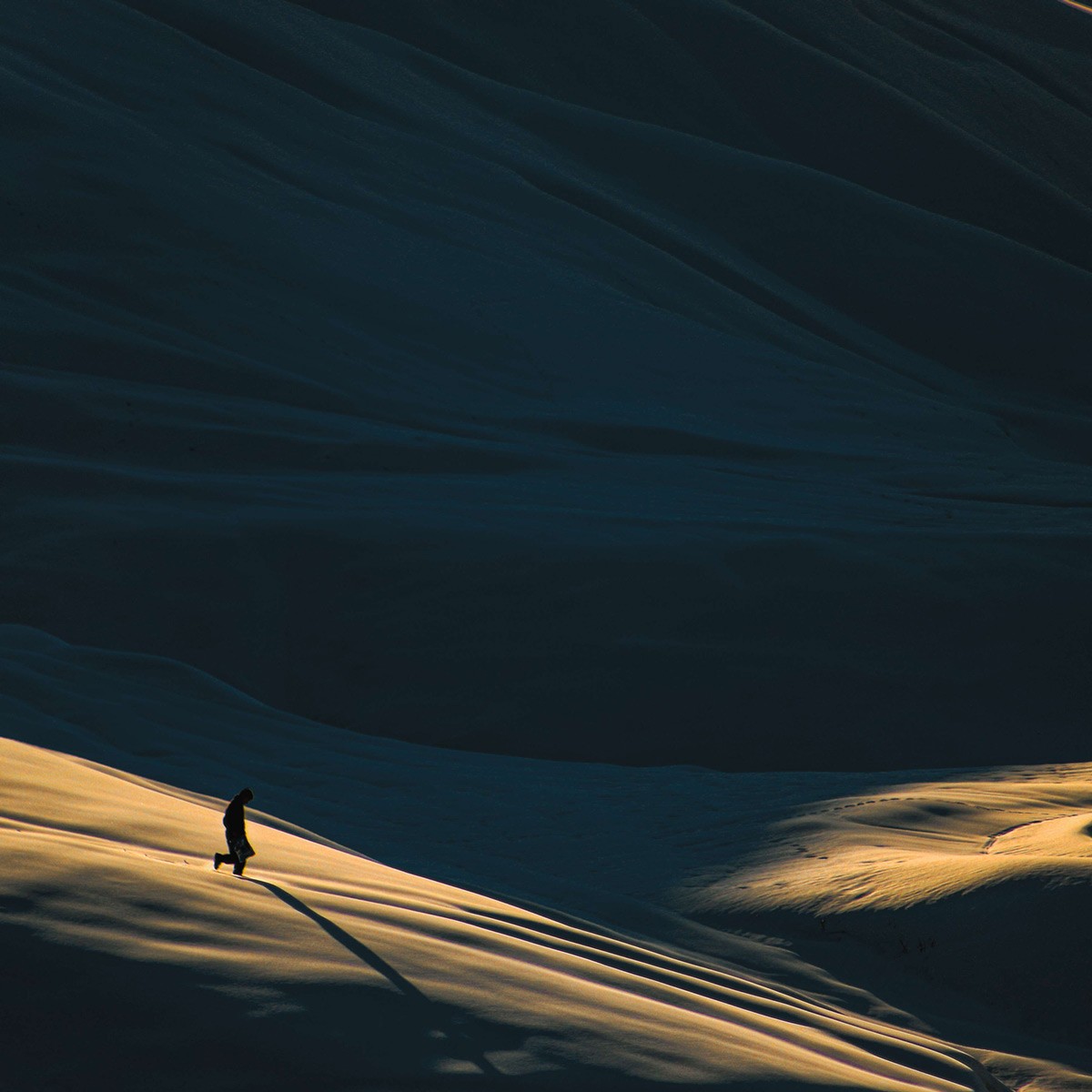 Man Strolling Through Desert Landscape Photo | Minimal Photo 3