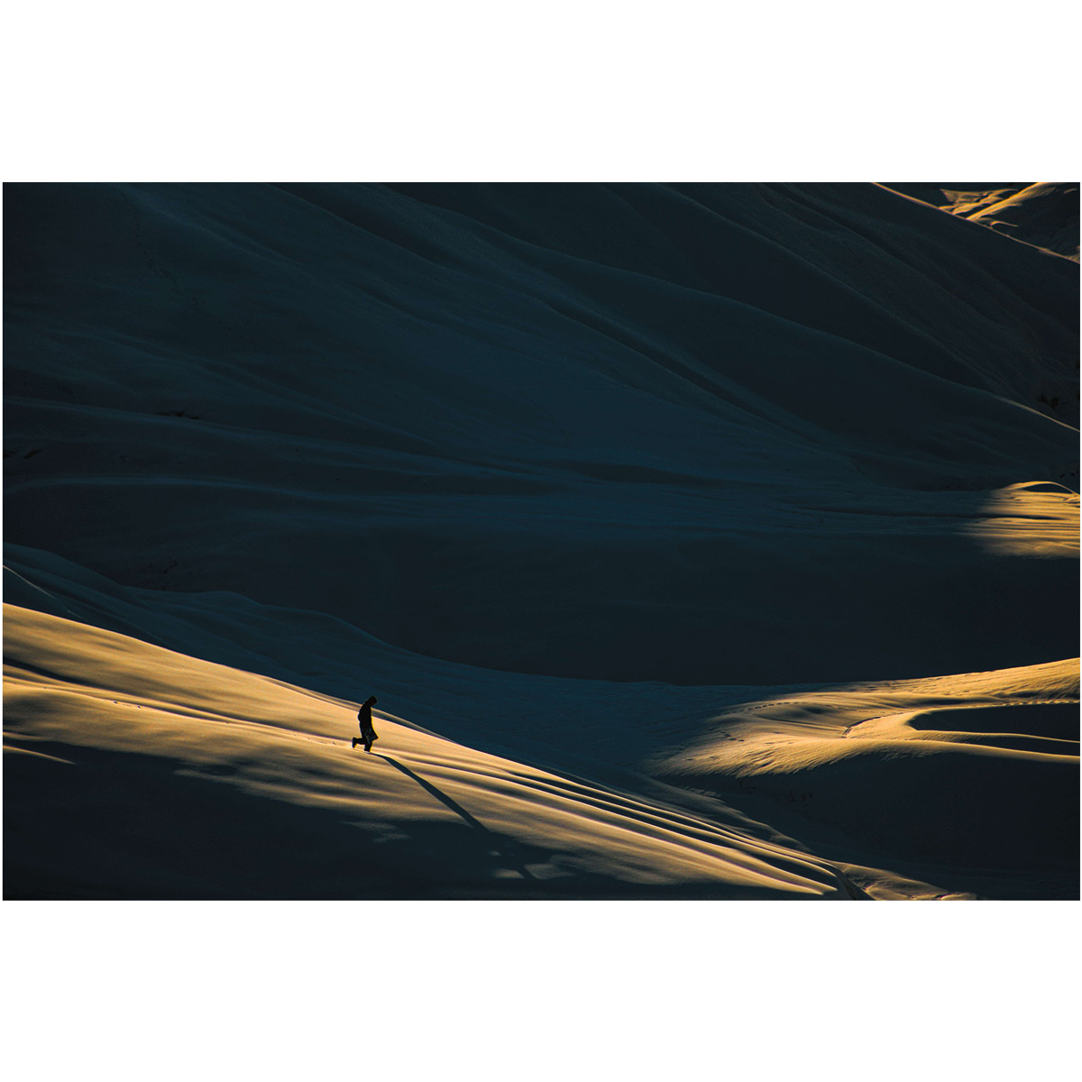 Man Strolling Through Desert Landscape Photo | Minimal Photo